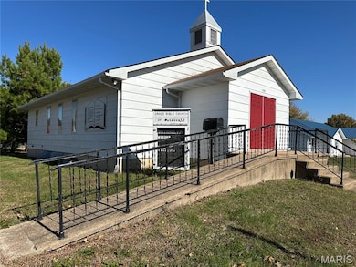 View of side of home with a lawn