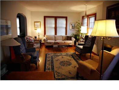Living room with hardwood floors facing West.