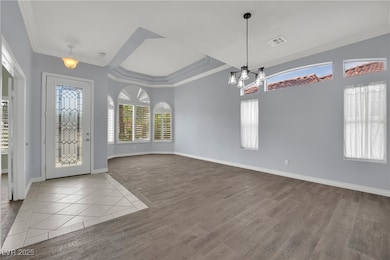 Entrance foyer with a chandelier, wood finished fl