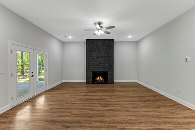 Unfurnished living room featuring ceiling fan, LVP flooring, a fireplace, and recessed lighting