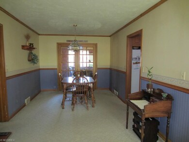 Dining area with crown molding, chair rail and fre