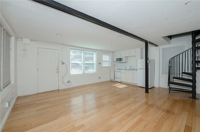 Unfurnished living room with light wood finished f