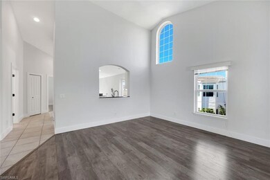 Unfurnished living room featuring wood-type floori