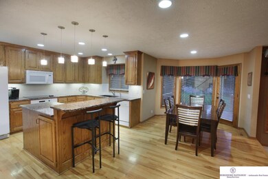 Granite, Large Center Island, Wood Floors and Planning Desk