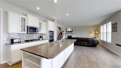 Past Office down the hallway is this Gorgeous, Open, & Bright Family Room & Incredible Kitchen!