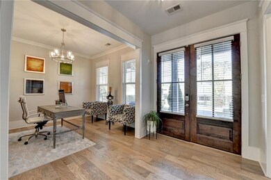Office area featuring light wood-style floors, cro