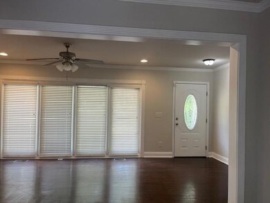 Foyer with a ceiling fan, crown molding, dark wood-type flooring, and recessed lighting