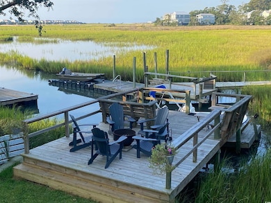 Dock area with a rural view and a water view