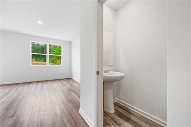 Bathroom with baseboards, wood finished floors, a 