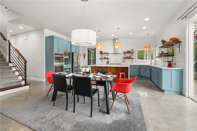 Open-concept eat-in kitchen with access to the porch.