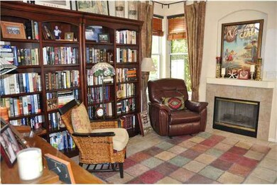 Living room with custom fireplace and wine closet