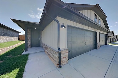 View of exterior entry with driveway and a garage