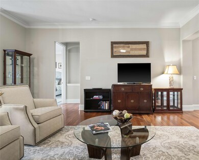 Living room featuring ornamental molding and wood-