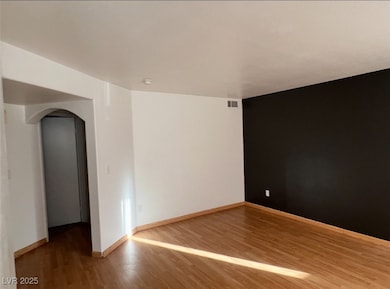Empty room with arched walkways and wood finished