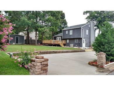 Back of house with huge concrete parking area for 