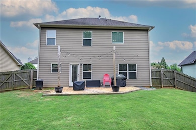 Back of house with a patio area and a gate