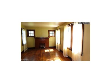 Faux fireplace in the living room. Four windows gi