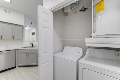 Washroom featuring washer and clothes dryer and l