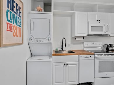 Kitchen featuring white cabinetry, white appliance