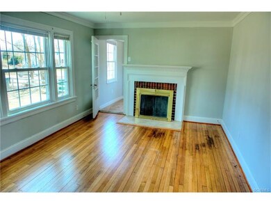 Living room with refinished wood floors and fresh 