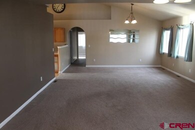 Enter into a spacious living room with vaulted cei