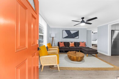 Living room with ceiling fan, ornamental molding, 