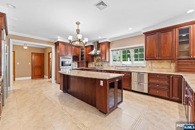 Chefâ€™s Kitchen Anchors the Home with Abundant Cabinetry Flowing Effortlessly into a Welcoming Family Room