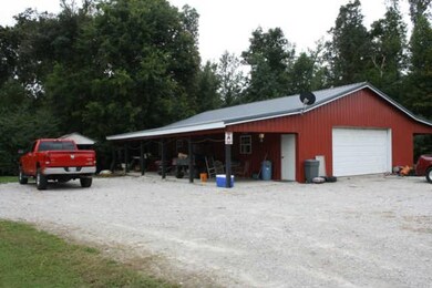 Massive 30X60 Detached  2 Car Garage/Workshop Offers Plenty Of Options To Store Your Vehicles, Lawn Equipment, And/Or Toys. Large 12X60  Covered Overhang On Each Side Allows Additional Room To Keep Your Personal Belongings Covered From The Elements