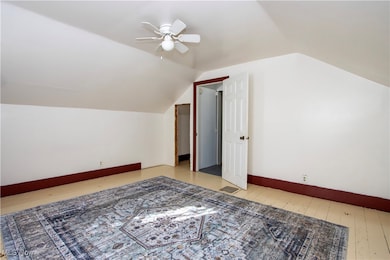 Bonus room with light wood finished floors, lofted ceiling, and ceiling​​‌​​​​‌​​‌‌​​​‌​​‌‌​​‌‌​‌​​​‌‌​​‌​​​​​‌ fan