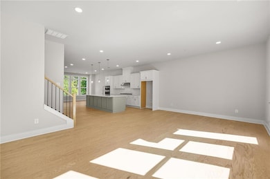 Unfurnished living room featuring recessed lighting, stairs, and light wood finished floors