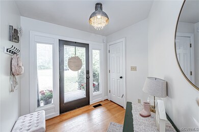 Hardwood floored foyer with natural light