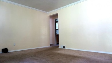 The entryway and living room, which leads to the f