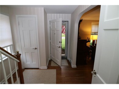 The front entryway with hardwood floor and arched 