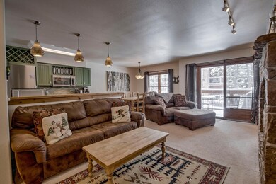 Living room featuring light carpet, rail lighting,