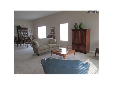 Spacious Great room offers neutral carpeting and v