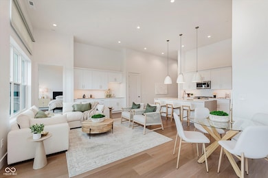 living room featuring towering ceilings, and recessed lighting