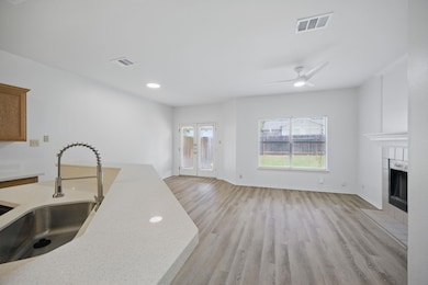 Kitchen featuring a sink, light wood-style floors