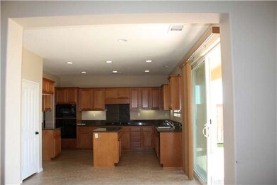 Large kitchen with granite counter tops and a butl