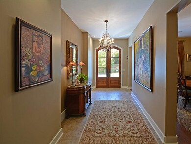 As you enter the home through a covered arched ent