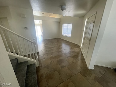 Foyer featuring a textured ceiling, visible vents,