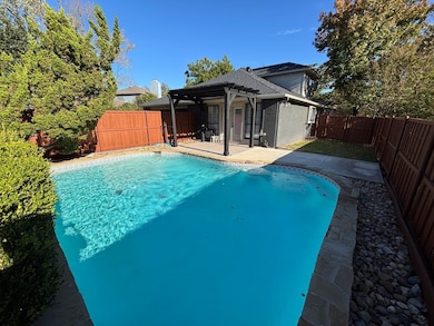 View of pool featuring a fenced backyard, a patio area, and a pergola
