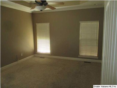 Master bedroom is large with boxed ceiling and cro