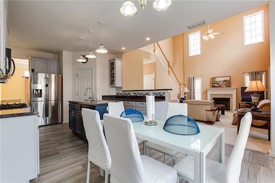 Dining area with hardwood / wood-style floors, sink, and ceiling fan
