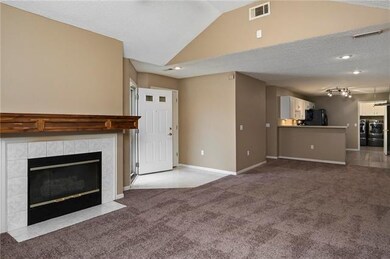 Living room area, fireplace, dining space into kit