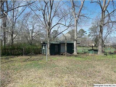 Property is fenced and storage building sits at ba