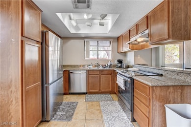 Kitchen with stainless steel appliances, under cab