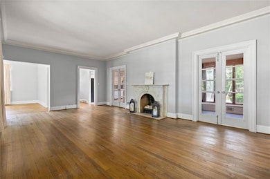 View of the living room, dining room, and sunroom.