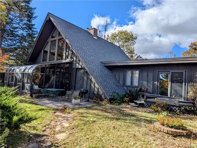 Back of home featuring 3 season room, patio, and d