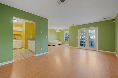 Unfurnished living room with french doors, light h