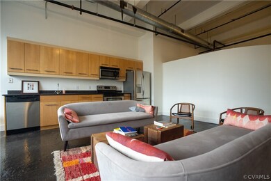 Living room featuring sink and a high ceiling